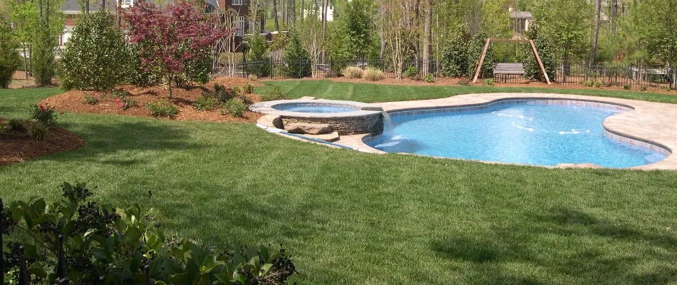 Well-manicured lawn next to a swimming pool in Youngsville, NC.