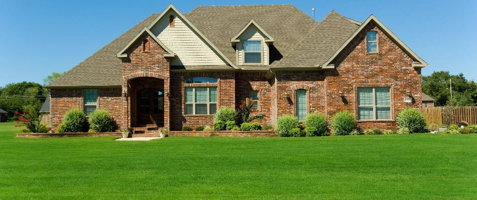 House in Morrisville, NC, with a green lawn and neat shrubs.