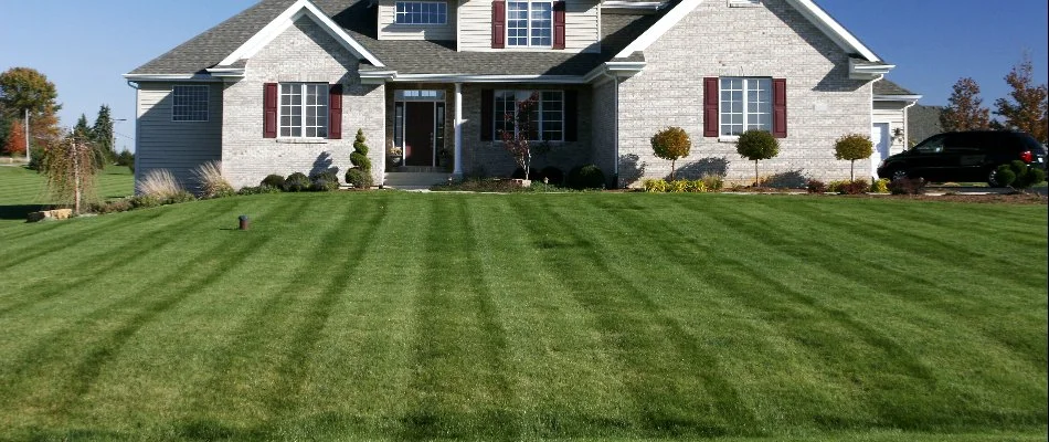 A large house in Cary, NC, and a front lawn with mowing stripes.