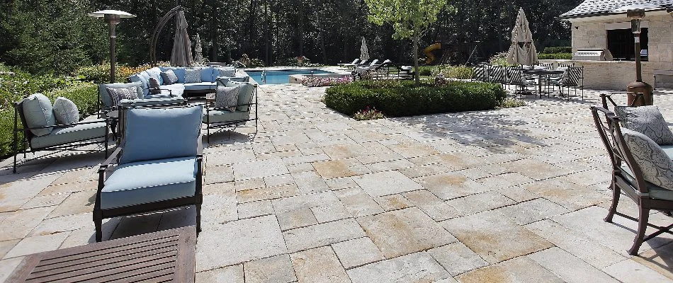 A light-colored paver patio in Cary, NC, with seating.