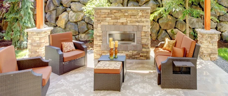 Outdoor fireplace in Cary, NC, with chairs and tables.