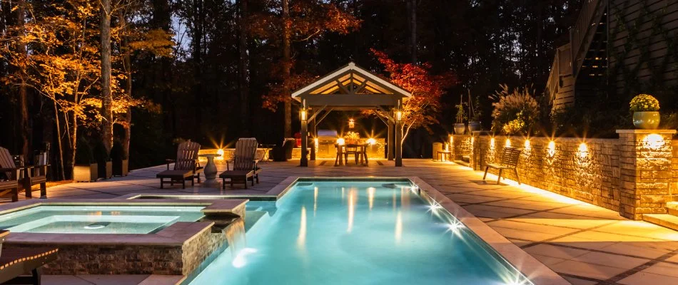 Outdoor space in Fuquay-Varina, NC, with pool, pavilion, outdoor lighting, and trees.