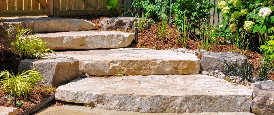 Outdoor steps in Cary, NC, with plants and mulch.