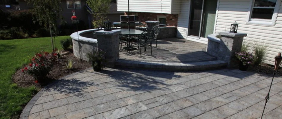 Two-tier paver patio in a backyard in New Hill, NC.