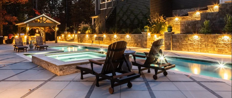 Pool in Cary, NC, with lounge chairs, pavilion, and outdoor lighting.